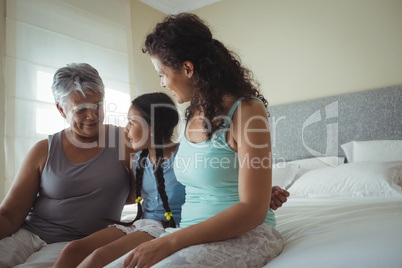 Happy family having fun on bed in bed room