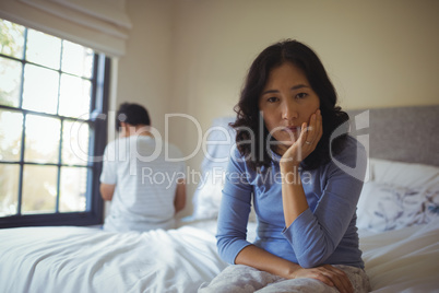 Couple ignoring each other in bedroom