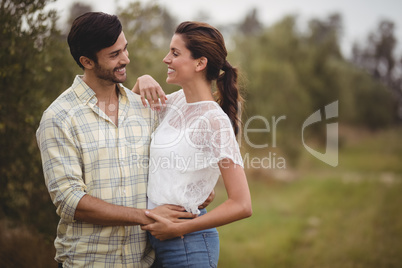 Young couple embracing at olive farm