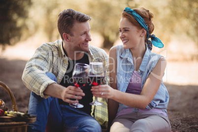 Smiling young man and woman toasting wineglasses