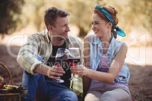 Smiling young man and woman toasting wineglasses