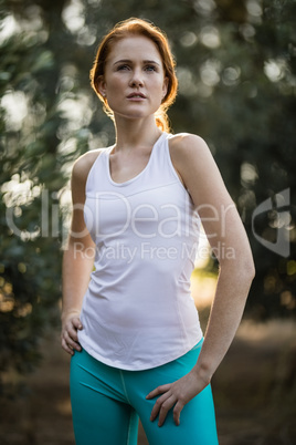 Young woman standing on field at farm