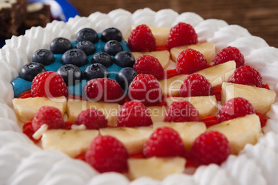 Fruitcake served in plate on wooden table