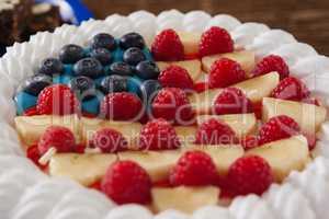 Fruitcake served in plate on wooden table