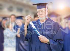 Proud Senior Adult Man In Cap and Gown At Outdoor Graduation Cer
