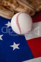 Baseball and gloves on an American flag