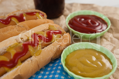 Hot dog and sauces on brown paper