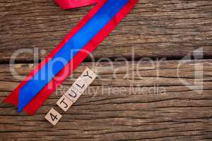 Date blocks with red and blue ribbon on table