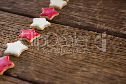 Red and white sugar cookies arranged on wooden table