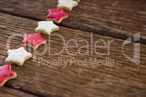 Red and white sugar cookies arranged on wooden table