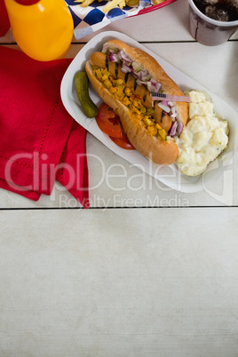 American flag and hot dog on wooden table