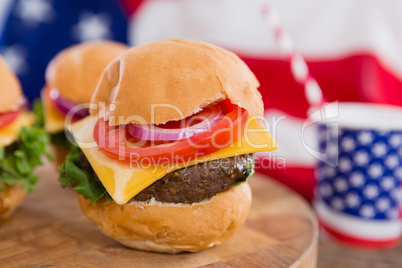 American flag and burgers on wooden table