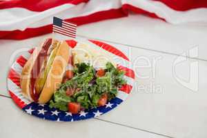 American flag and hot dog on wooden table