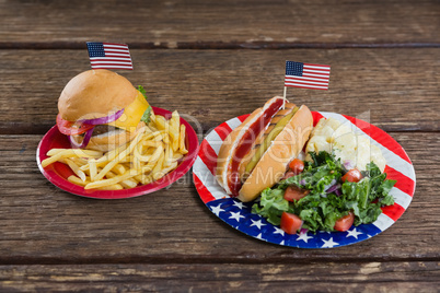 Burger and hot dog on wooden table with 4th july theme