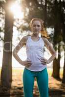 Portrait of confident young woman standing on field