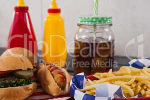 Close-up of snacks and cold drink on wooden table