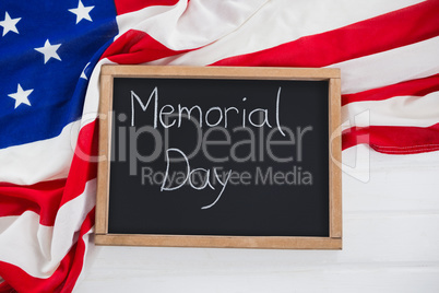 Slate with text and an American flag on wooden table