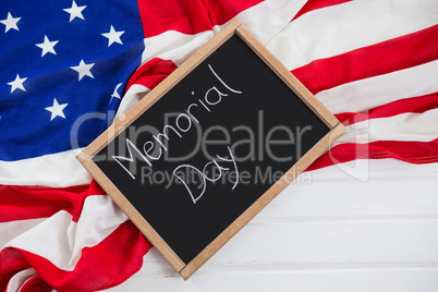 Slate with text and an American flag on wooden table