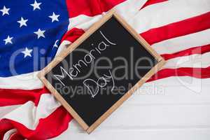 Slate with text and an American flag on wooden table