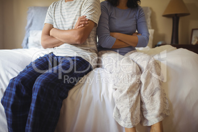 Couple ignoring each other in bedroom