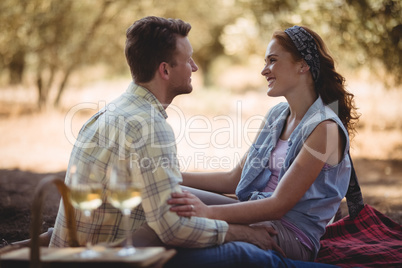 Loving young couple sitting on mat