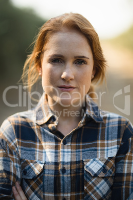 Portrait of beautiful young woman at farm