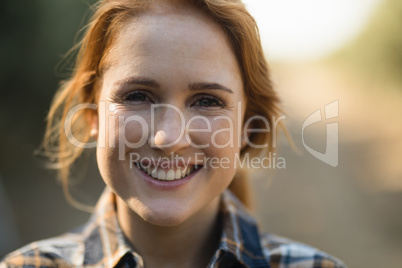 Portrait of smiling young woman at farm