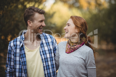 Cheerful couple looking at each other at olive farm