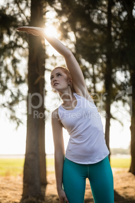 Young woman exercising on field at farm
