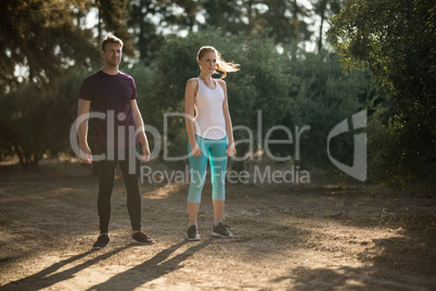 Determined young couple standing on field at farm