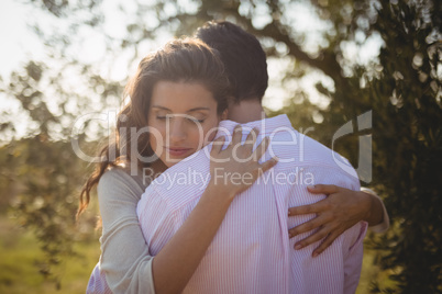 Young woman hugging boyfriend at farm