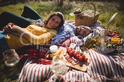 Portrait of happy young couple lying together on blanket