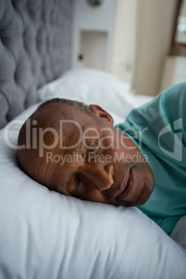 Close up of senior man sleeping on bed