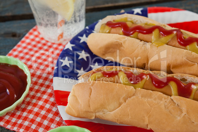 Close-up of hot dog served in plate on wooden table