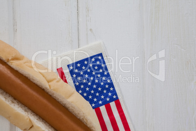 Hot dog and American flag on white wooden table