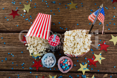 Popcorn, sweet food and cold drink decorated with 4th july theme
