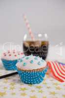 Close-up of drink and cupcake with 4th july theme