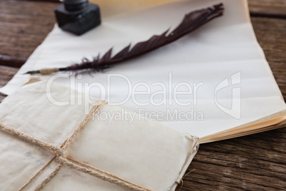 Quill feather, ink pot, and legal documents arranged on table