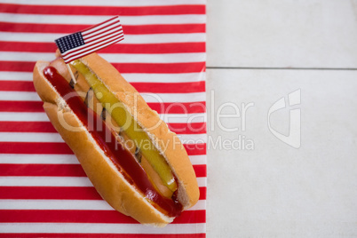 American flag and hot dog on wooden table