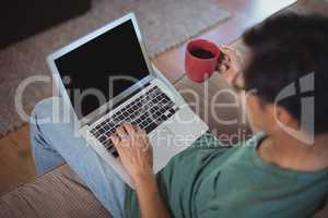 Man using laptop in living room