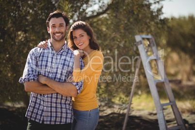 Portrait of young couple embracing at farm