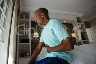 Side view of senior man suffering from stomachache at home