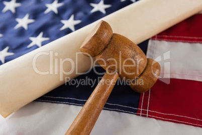 Gavel and rolled-up document arranged on American flag