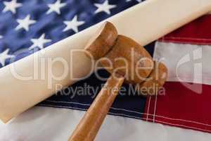 Gavel and rolled-up document arranged on American flag