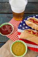 Hot dog served on plate with french fries