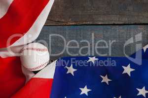 Baseball and American flag on wooden table