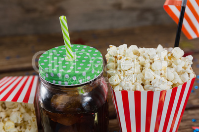 Close-up of popcorn and cold drink