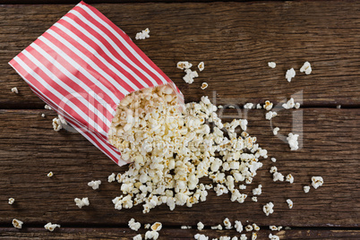 Scattered popcorn on wooden table