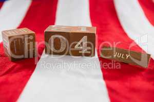 Date blocks on American flag with 4th july theme