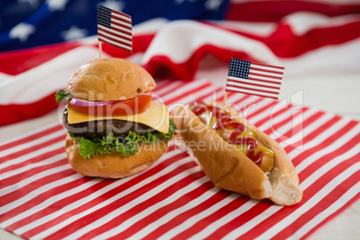 American flag with hot dog and burger on wooden table
